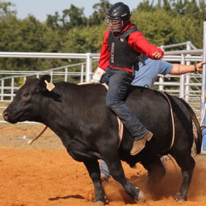 Aiden from OBHC Boys Ranch Town is riding a bull