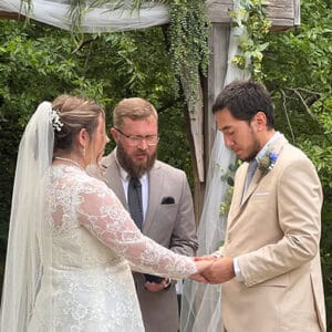 A wedding photo of Misael, his wife and pastor after he left OBHC