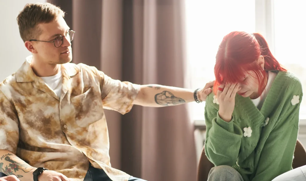 Dad comforts teen in counseling